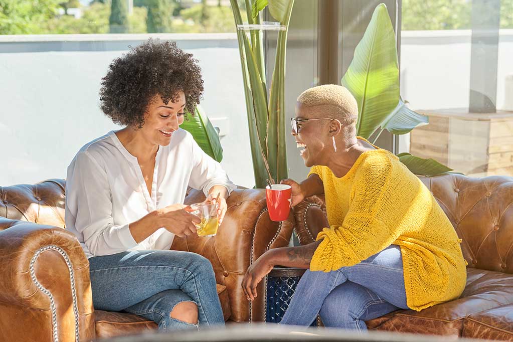 cheerful-diverse-women-having-fun-on-sofa-at-home-2025-04-04-02-12-36-utc