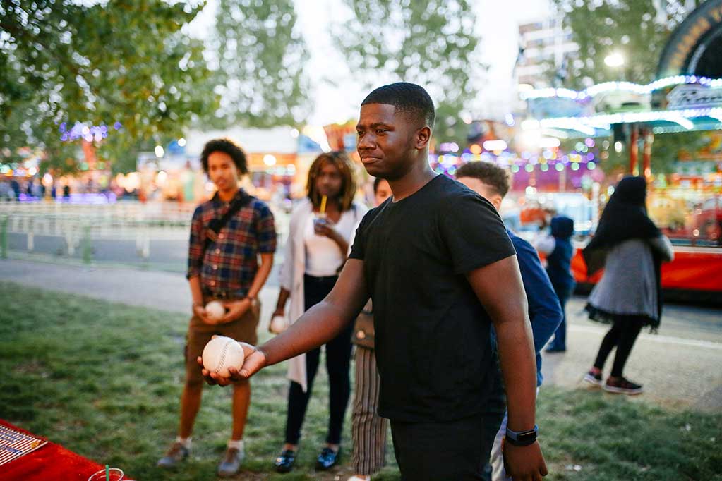 group-of-friends-at-funfair-boy-holding-ball-loo-2025-04-04-22-04-12-utc
