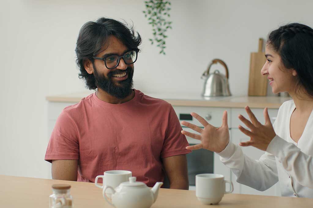 happy-multiracial-couple-drink-coffee-tea-in-home-2025-03-24-00-14-00-utc