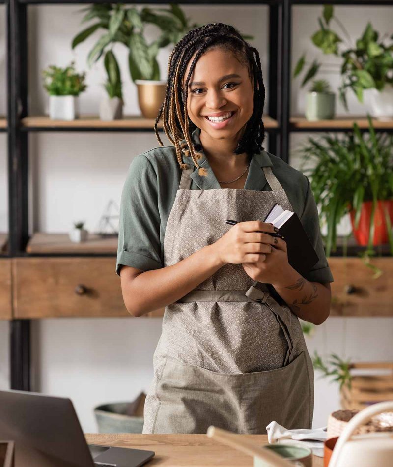 smiling-woman-with-braids-holding-notebook-in-flow-2026-01-11-08-21-001-utc